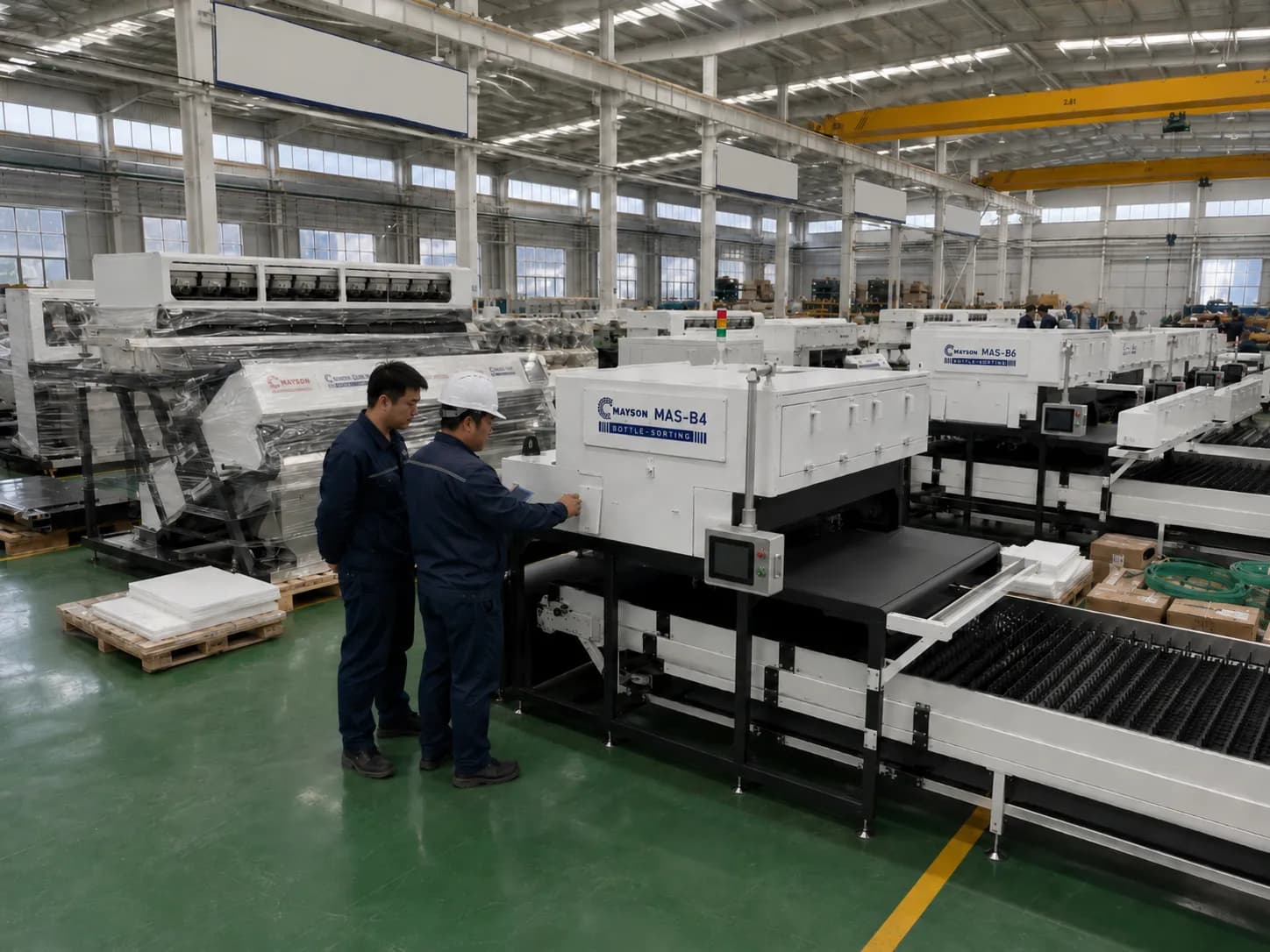 Technicians checking a MAS bottle sorter on the assembly line